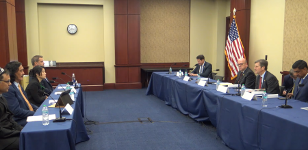 A wide shot of hearing witnesses on the left, and congressmen on the right during a hearing about human rights